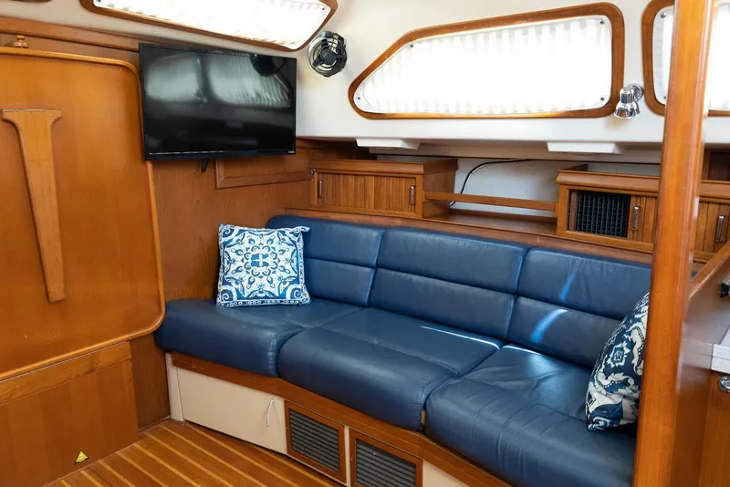 Slide: The Image of Luxurious interior of 2004 Island Packet 485 yacht with blue leather seating and decorative pillows. - 21