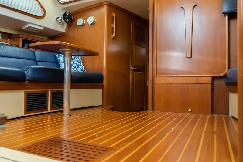 Slide: The Image of Interior of 2004 Island Packet 485 yacht with wooden flooring and blue seating. - 22