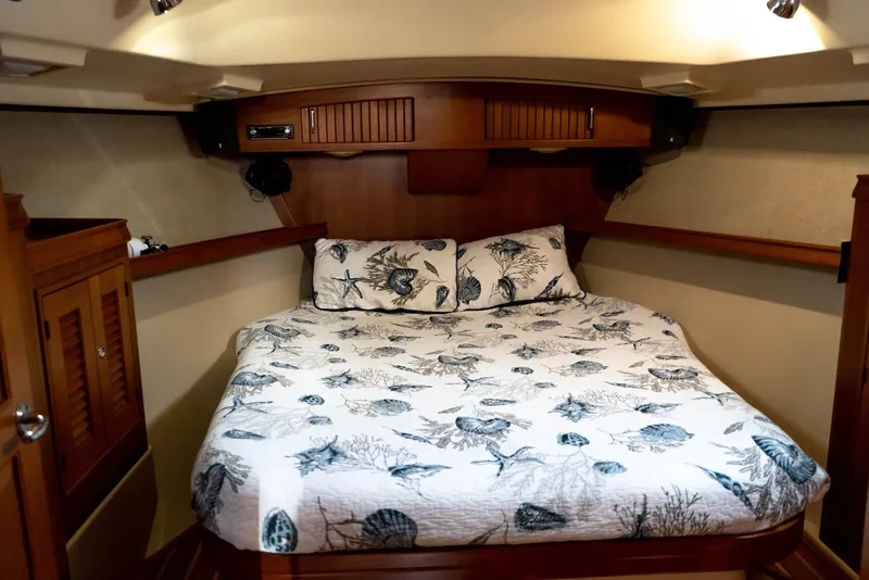 Slide: The Image of Cozy cabin interior of 2004 Island Packet 485 yacht with nautical-themed bedding. - 30