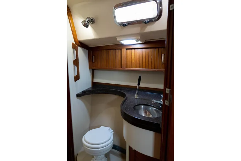 Slide: The Image of 2004 Island Packet 485 yacht bathroom with wooden cabinets and modern fixtures. - 34