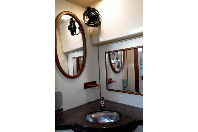 Slide: The Image of Bathroom vanity with mirrors and sink on 2004 Island Packet 485 yacht. - 42
