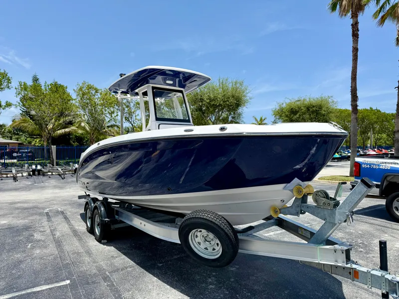 The Image of 2025 Yamaha Boats 255 FSH Sport H on trailer, parked outdoors under clear sky. - 0