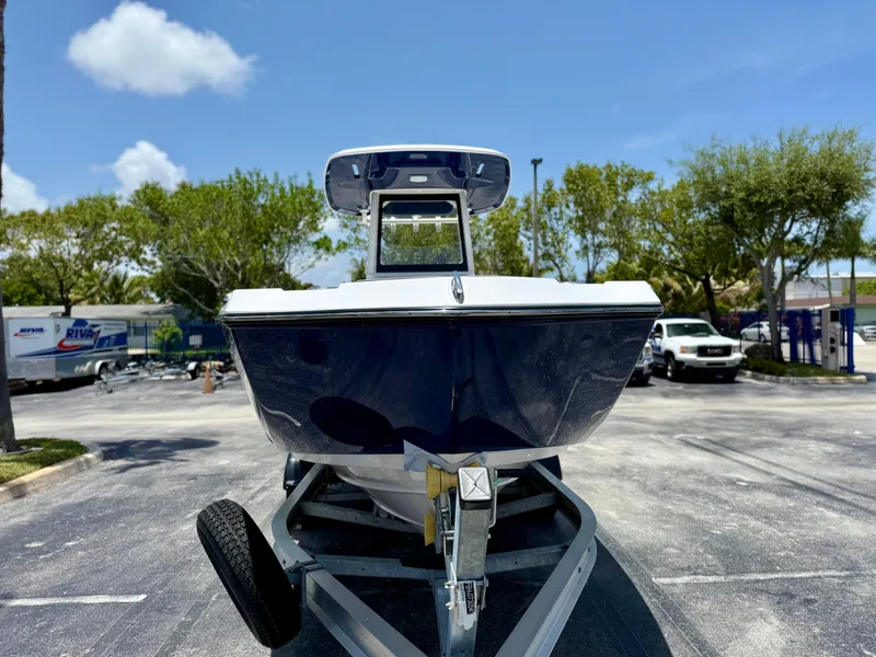 Slide: The Image of 2025 Yamaha Boats 255 FSH Sport H on trailer, parked outdoors under clear sky. - 1