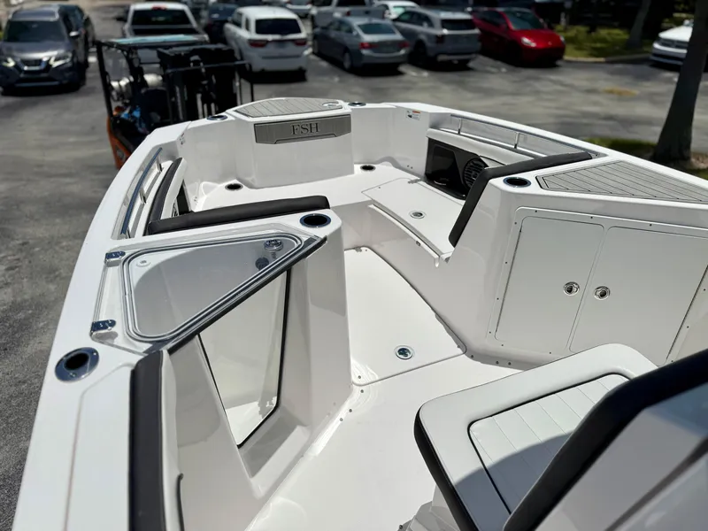 Slide: The Image of 2025 Yamaha Boats 255 FSH Sport H interior with seating and storage compartments. - 10