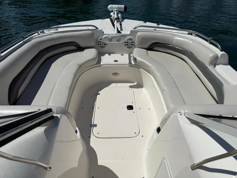 Slide: The Image of 2006 Hurricane SD 237 boat interior with spacious seating and sleek design on water. - 10