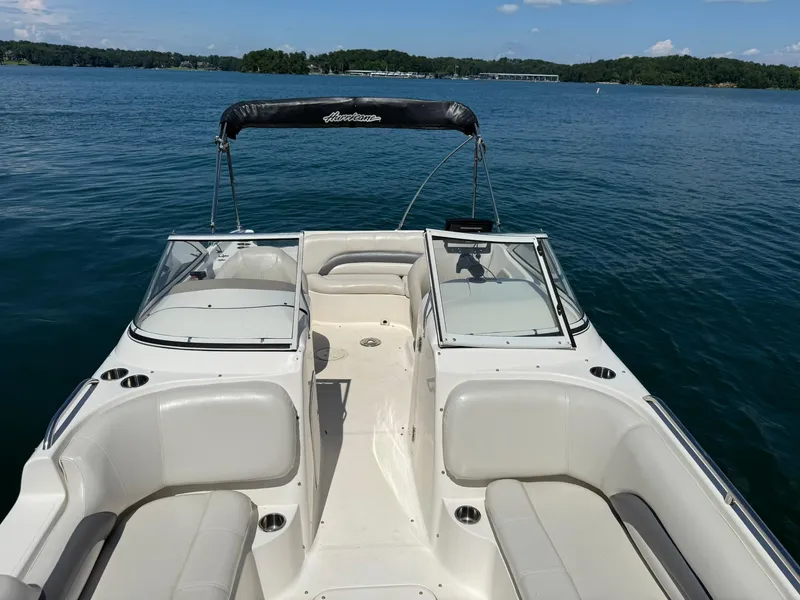 Slide: The Image of 2006 Hurricane SD 237 boat on a serene lake with clear blue water. - 13