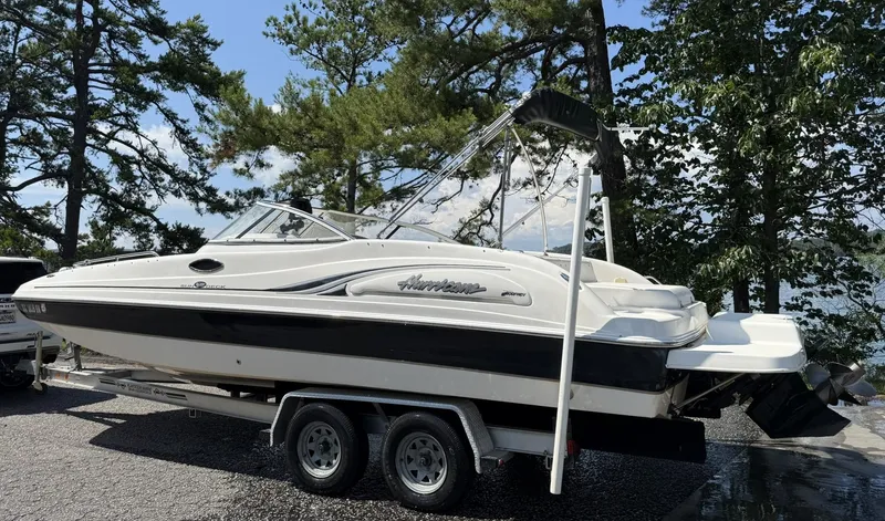 Slide: The Image of 2006 Hurricane SD 237 boat on trailer, surrounded by trees and water in the background. - 5
