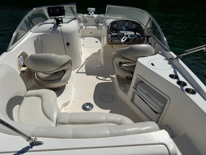 Slide: The Image of 2006 Hurricane SD 237 boat interior with seating, steering wheel, and control panel on water. - 7