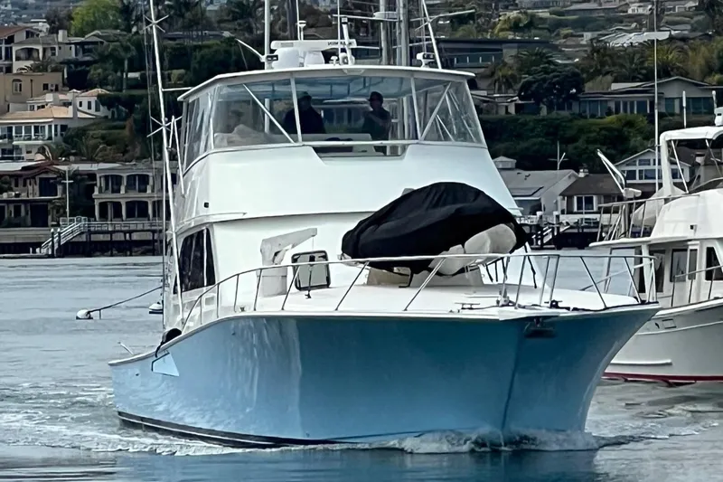 Slide: The Image of Viking Boats 65 C, 2000 model, cruising in a marina with waterfront homes. - 1