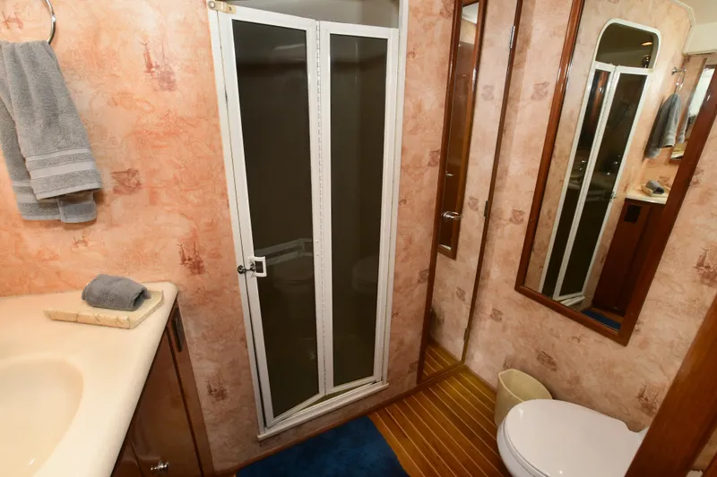 Slide: The Image of Bathroom interior of 2000 Viking Boats 65 C with shower, sink, and toilet. - 10