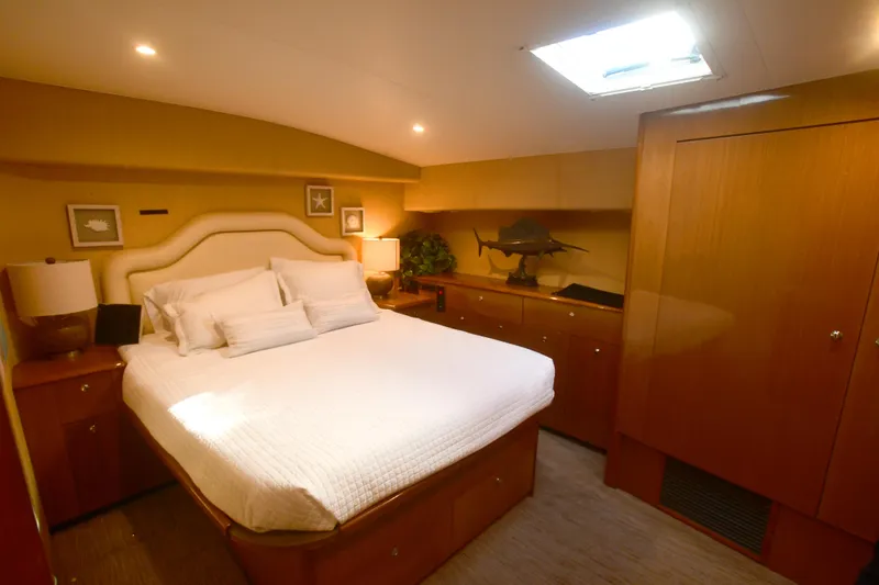 Slide: The Image of Luxurious bedroom interior of 2000 Viking Boats 65 C yacht with elegant wood finishes. - 14