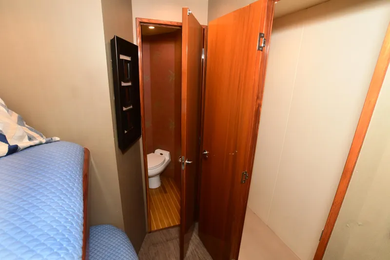 Slide: The Image of Interior of 2000 Viking Boats 65 C, featuring a cozy cabin and bathroom. - 16