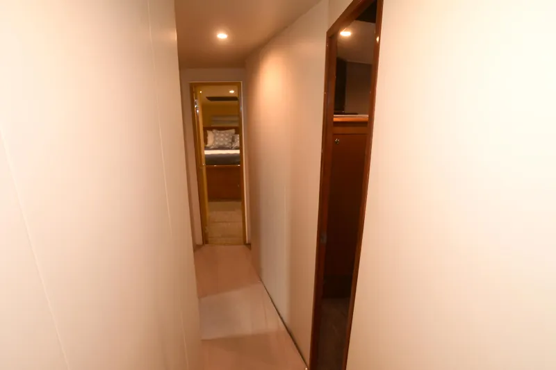 Slide: The Image of Narrow hallway inside 2000 Viking Boats 65 C, leading to a cozy cabin. - 19