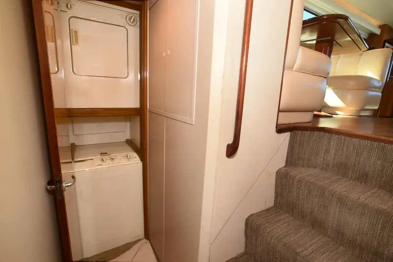 Slide: The Image of Laundry area in 2000 Viking Boats 65 C yacht with stacked washer and dryer. - 21