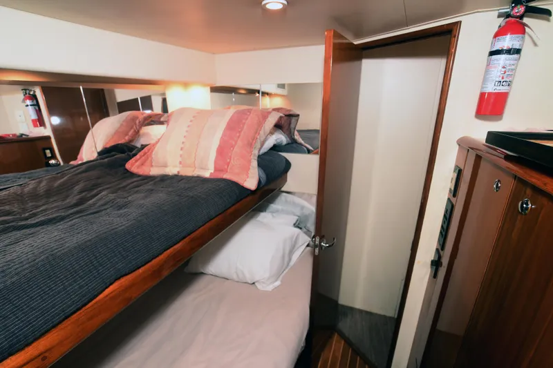 Slide: The Image of Interior cabin of 2000 Viking Boats 65 C with bunk beds and fire extinguisher. - 23