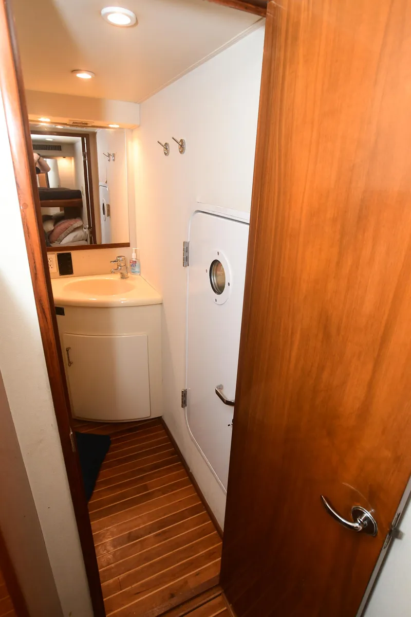 Slide: The Image of Bathroom interior of 2000 Viking Boats 65 C yacht with wooden flooring and compact sink. - 25