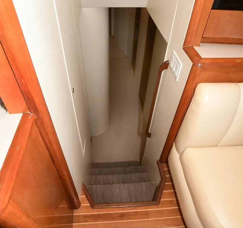 Slide: The Image of Staircase inside 2000 Viking Boats 65 C, featuring wooden and carpeted steps. - 32