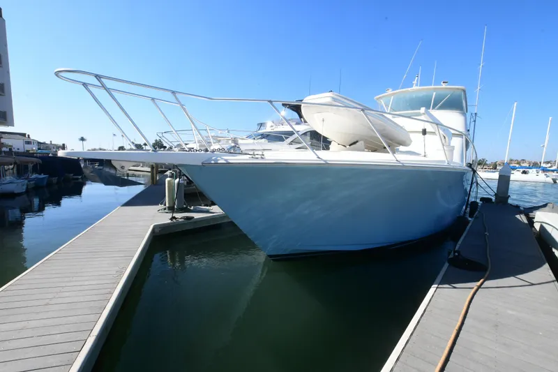 Slide: The Image of 2000 Viking Boats 65 C yacht docked at marina under clear blue sky. - 47