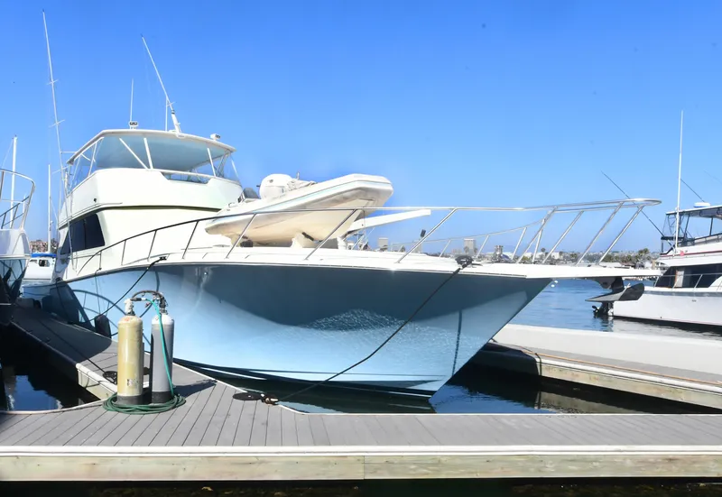 Slide: The Image of Viking Boats 65 C, 2000 model, docked at marina under clear blue sky. - 48
