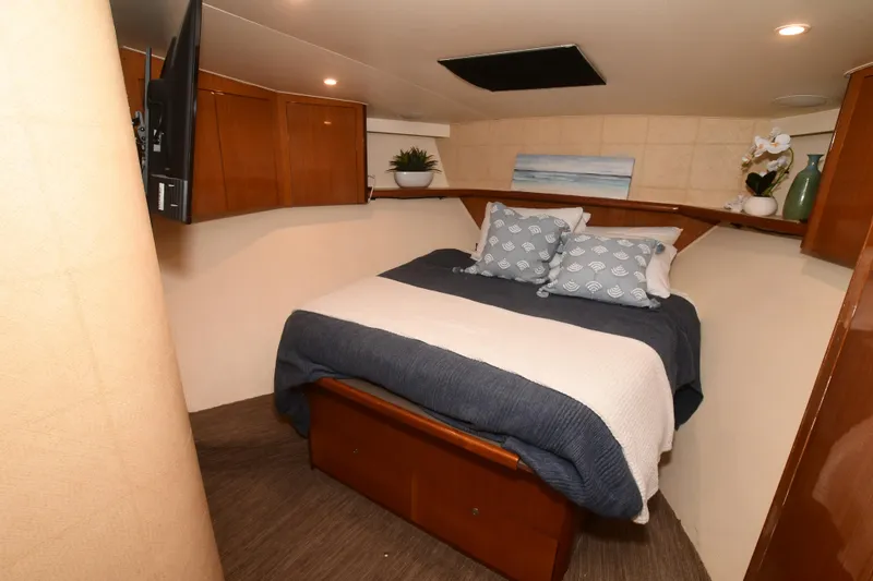 Slide: The Image of Cozy bedroom in 2000 Viking Boats 65 C yacht with elegant decor and modern amenities. - 8