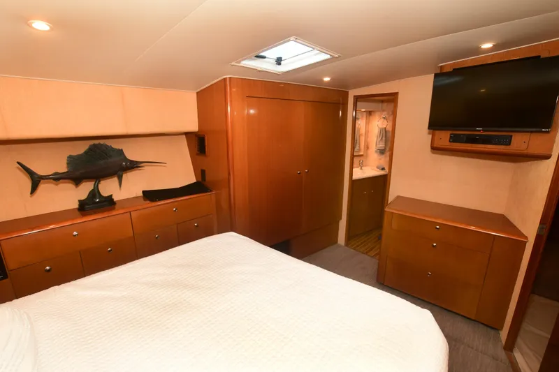 Slide: The Image of Luxurious cabin interior of 2000 Viking Boats 65 C, featuring wood cabinetry and modern amenities. - 9