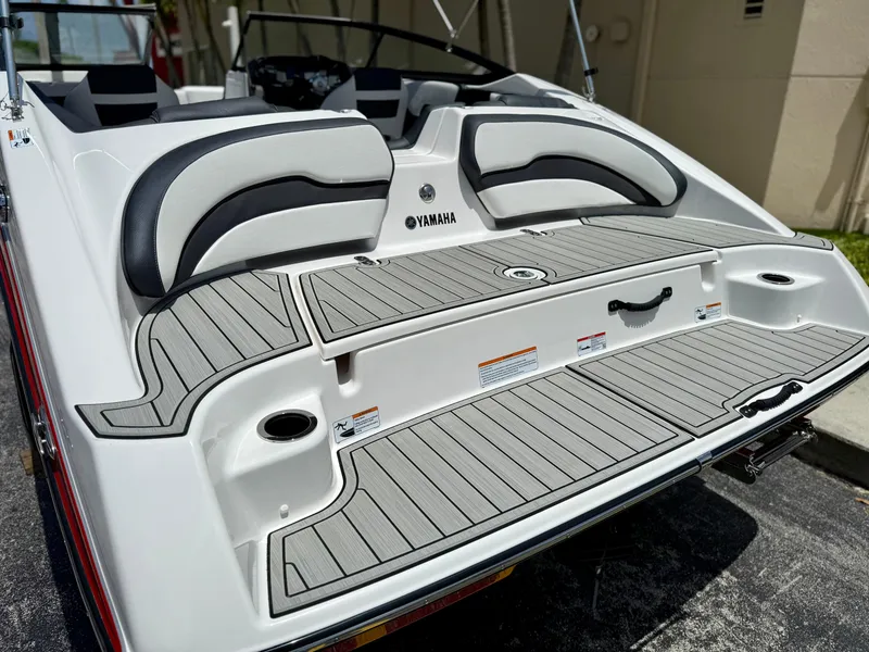 Slide: The Image of 2025 Yamaha SX195 boat rear view with sleek seating and deck design. - 8