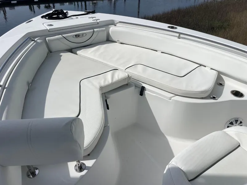 Slide: The Image of 2017 Sea Hunt Ultra 234 boat with white cushioned seating in the bow area. - 10
