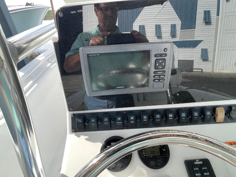 Slide: The Image of Control panel of a 2017 Sea Hunt Ultra 234 boat with navigation equipment. - 13