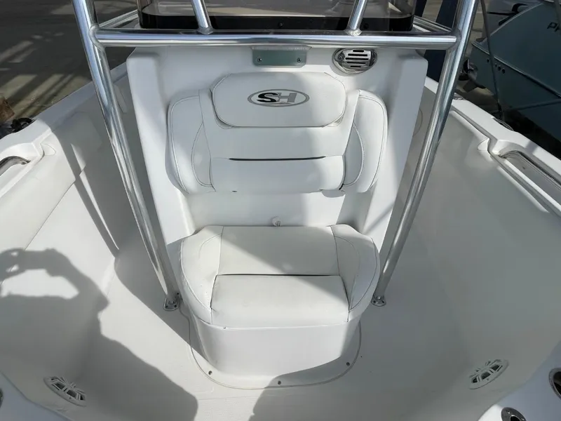 Slide: The Image of 2017 Sea Hunt Ultra 234 boat seat with white upholstery and stainless steel frame. - 15