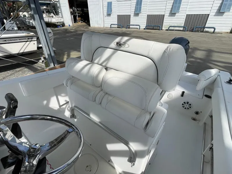 Slide: The Image of 2017 Sea Hunt Ultra 234 boat interior with white seating and steering wheel. - 16