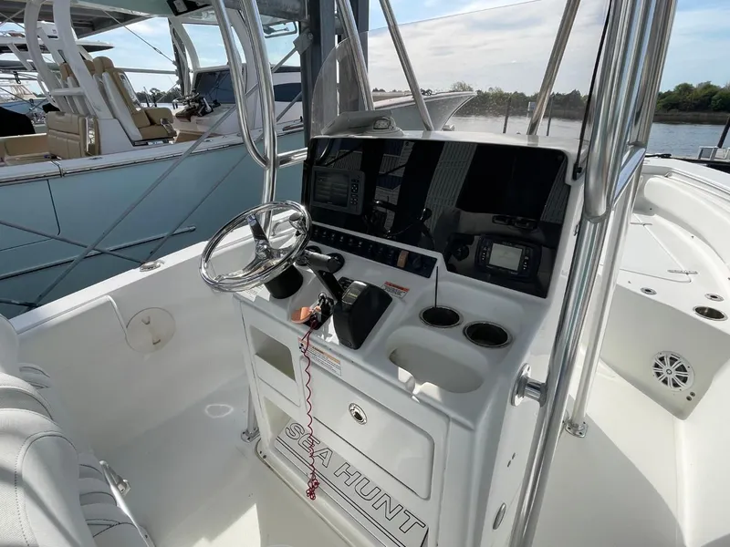 Slide: The Image of 2017 Sea Hunt Ultra 234 boat console with steering wheel and controls. - 19
