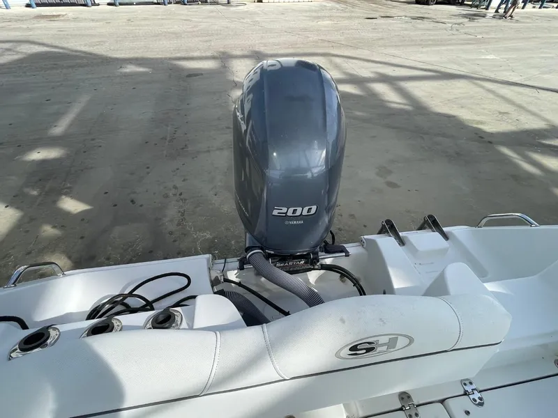 Slide: The Image of 2017 Sea Hunt Ultra 234 boat with Yamaha 200 engine, docked on concrete surface. - 20