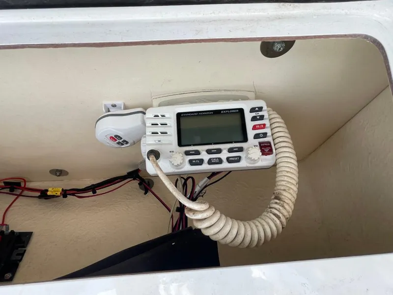 Slide: The Image of VHF marine radio installed in a 2017 Sea Hunt Ultra 234 boat compartment. - 24