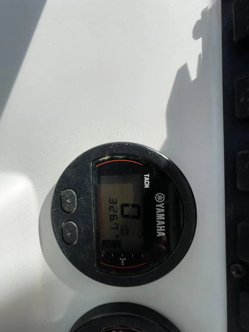 Slide: The Image of Yamaha tachometer on 2017 Sea Hunt Ultra 234 boat dashboard, displaying engine hours. - 26