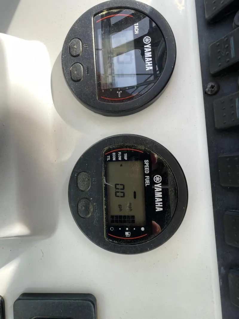Slide: The Image of Yamaha gauges on 2017 Sea Hunt Ultra 234 boat dashboard, displaying speed and fuel information. - 27