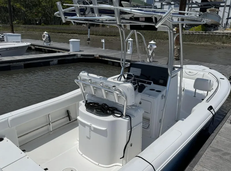 Slide: The Image of 2017 Sea Hunt Ultra 234 boat docked, featuring a sleek design and spacious seating. - 3