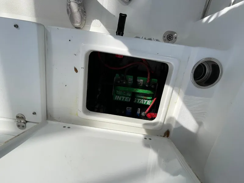Slide: The Image of Battery compartment of 2017 Sea Hunt Ultra 234 boat, featuring Interstate battery. - 31