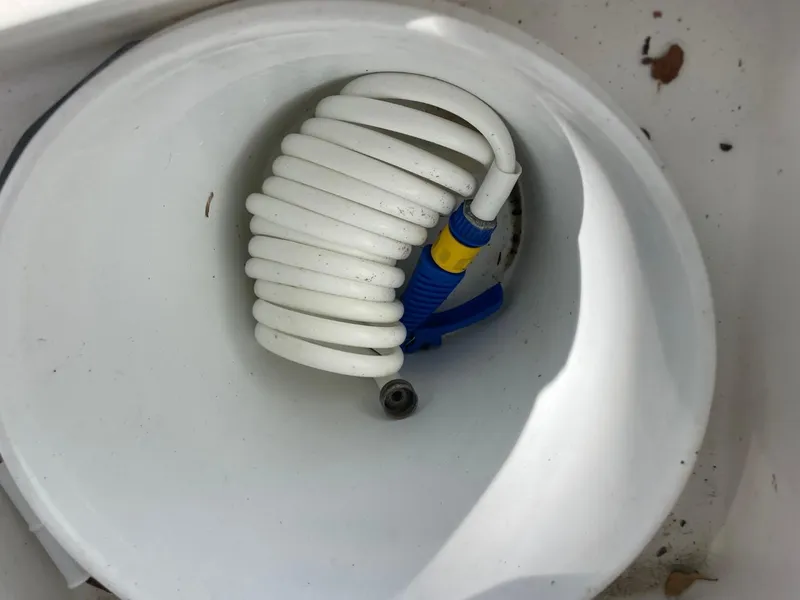 Slide: The Image of Coiled hose in 2017 Sea Hunt Ultra 234 boat compartment. - 32