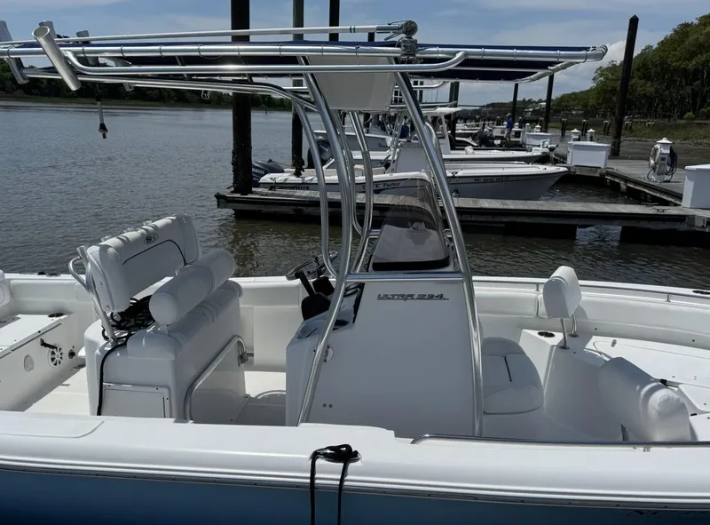 Slide: The Image of 2017 Sea Hunt Ultra 234 boat docked, featuring sleek design and spacious seating. - 4
