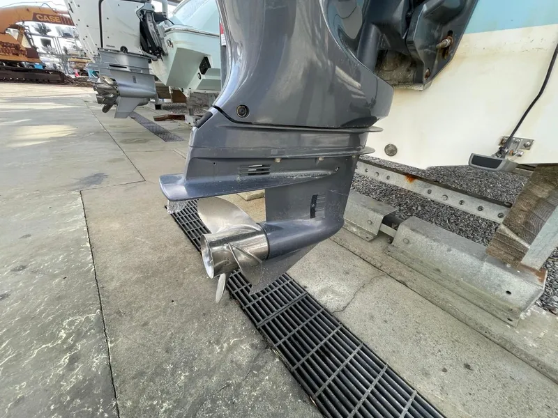 Slide: The Image of 2017 Sea Hunt Ultra 234 outboard motor close-up in a marina setting. - 9