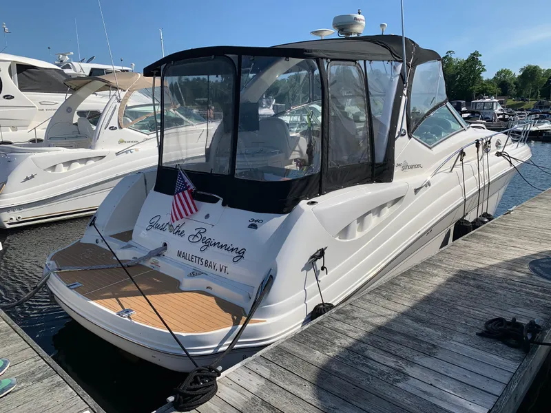 Slide: The Image of 2006 Sea Ray 340 Sundancer docked, featuring "Just the Beginning" name and American flag. - 10