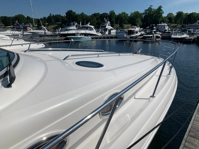 Slide: The Image of 2006 Sea Ray 340 Sundancer yacht docked at a marina on a sunny day. - 11
