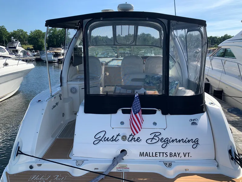 Slide: The Image of 2006 Sea Ray 340 Sundancer docked at Malletts Bay, Vermont, with American flag. - 13