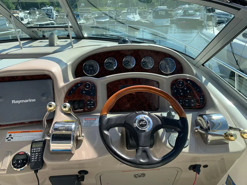 Slide: The Image of Helm of 2006 Sea Ray 340 Sundancer with Raymarine electronics and wood-accented steering wheel. - 18