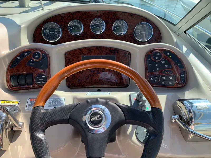 Slide: The Image of 2006 Sea Ray 340 Sundancer dashboard with wood accents and steering wheel. - 19
