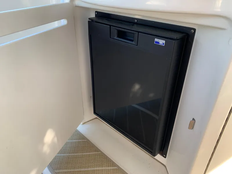 Slide: The Image of Compact refrigerator on 2006 Sea Ray 340 Sundancer boat, enclosed in white cabinetry. - 26
