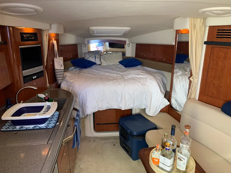 Slide: The Image of Interior of 2006 Sea Ray 340 Sundancer with bed, kitchenette, and seating area. - 27