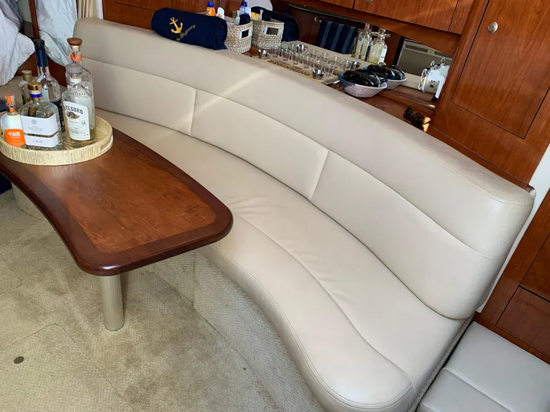 Slide: The Image of Luxurious interior of 2006 Sea Ray 340 Sundancer with leather seating and wooden table. - 29