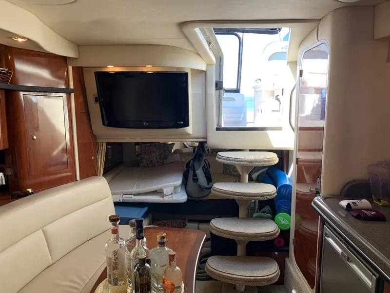 Slide: The Image of Interior of 2006 Sea Ray 340 Sundancer yacht with TV, seating, and bar area. - 35
