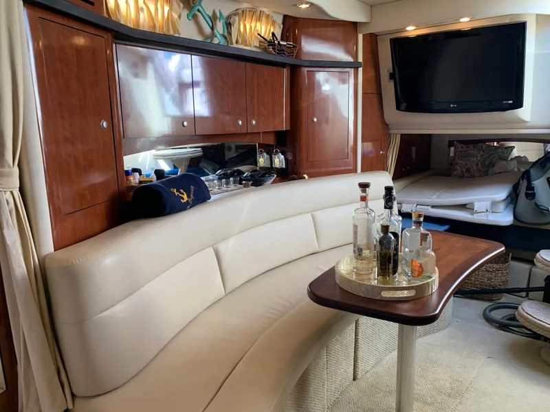 Slide: The Image of Luxurious interior of 2006 Sea Ray 340 Sundancer yacht with elegant seating and bar setup. - 36